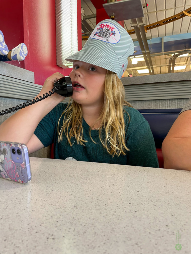 engineer Lizzie with free hat ordering on phone